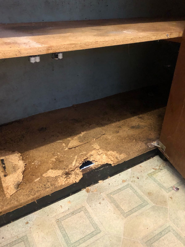 Before: damaged chipboard base and shelf inside a timber cupboard