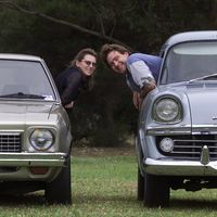 Jo Maree Penney's profile photo: two people leaning between vintage cars