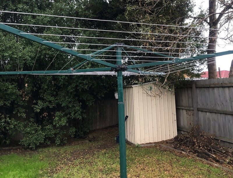 Backyard with a rotary clothesline, garden shed and timber fence